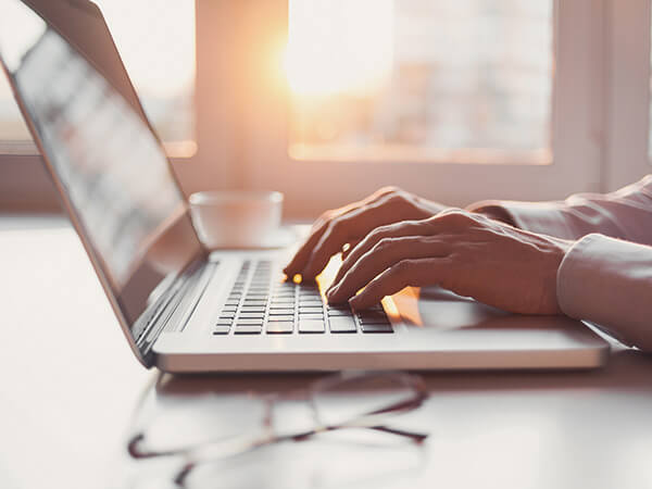 hands on a laptop image